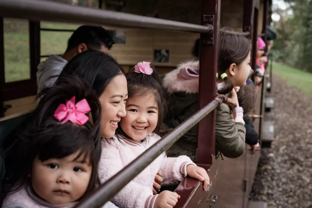 young-family-smiling-on-puffing-billy-steam-train